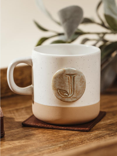 Customizable 10oz white speckled mug on customizable square leather coaster.