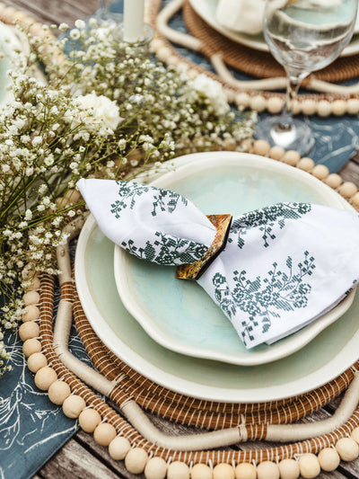 Spring table setting with flowers featuring screen printed jade embroidery napkin.