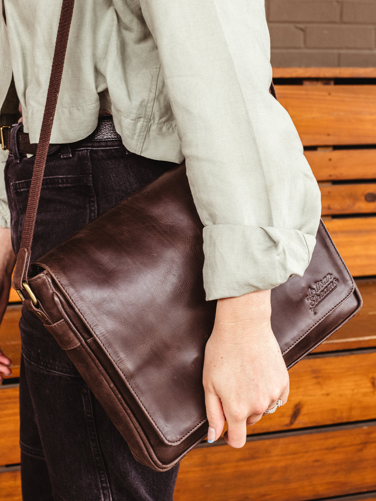 Female earring dark brown leather satchel.