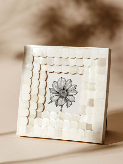 Square white scalloped frame made from bone, showcasing a detailed black and white floral illustration, displayed on a neutral background with soft shadows.