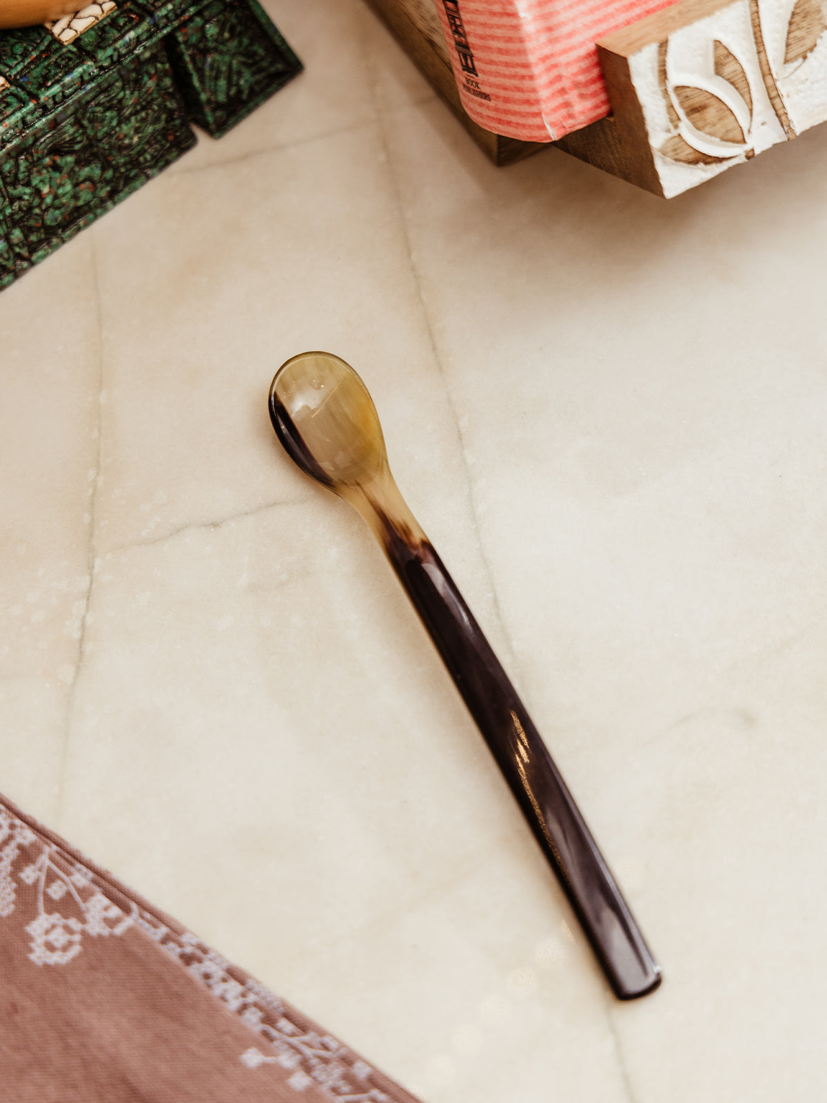 Long horn spoon on white counter.