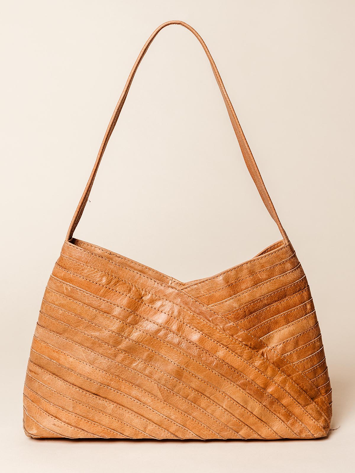 Front view of the Crisscross Leather Handbag, showcasing its unique diagonal leather pattern, soft tan color, and adjustable strap, ethically made and sold at Joffa.