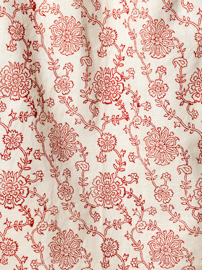 Detailed close-up of a red floral pattern on an artisan-crafted tea towel. Beautifully designed with sustainable materials, adding a touch of elegance to any home.