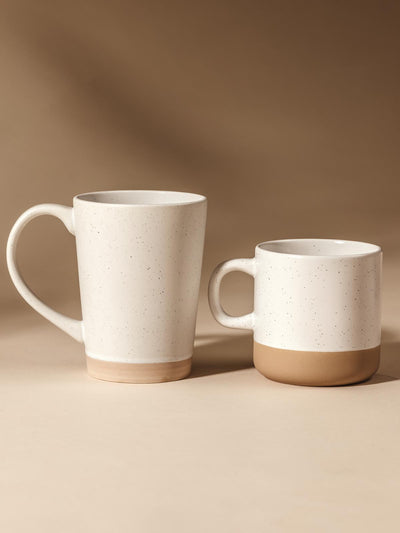 16 oz and 10 oz ceramic mugs on cream background.