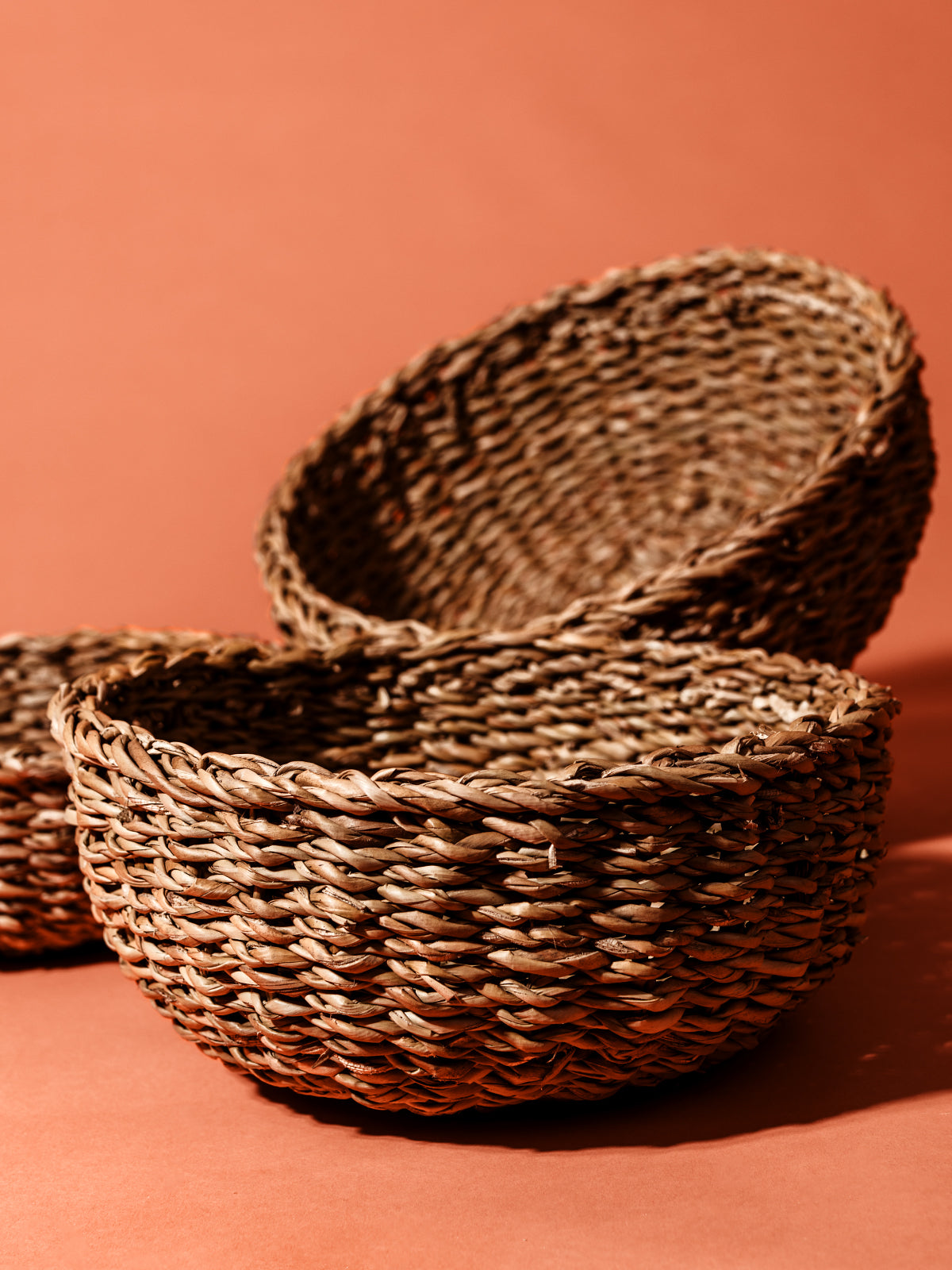 Close up detail of Seagram basket texture on rustic orange studio background.