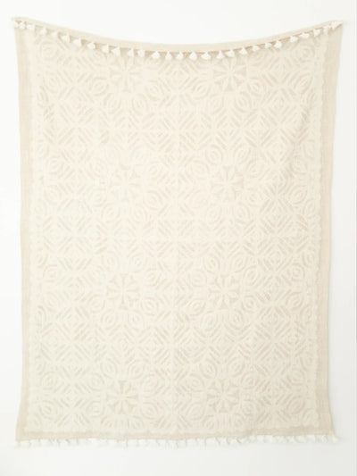 Whole cream cutwork throw on white background.