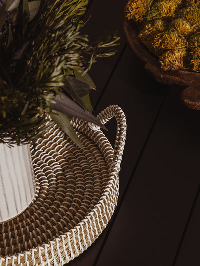 Kaisa tray on black coffee table with plant placed within. Closeup on tray texture and design. 