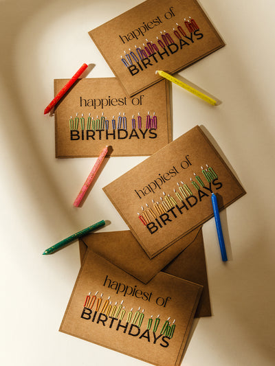 Handmade happy birthday cards with colorful embroidered candles on kraft paper, displayed alongside glitter birthday candles. Perfect for sending warm birthday wishes with a unique, handcrafted touch.