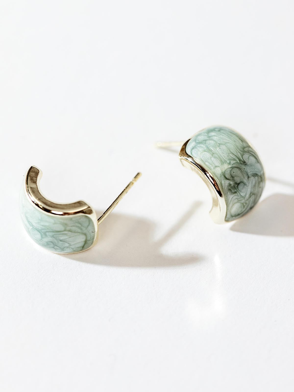 Sage half hoops on white background.