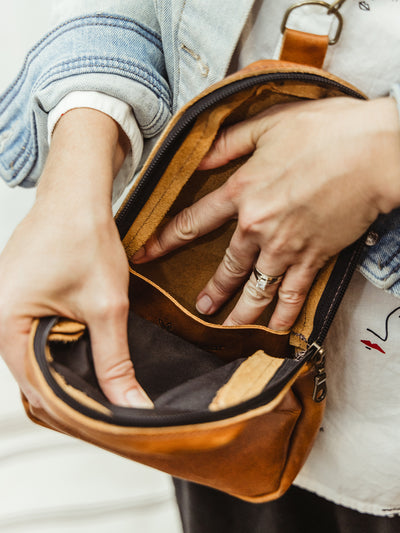 Interior pockets of genuine leather sling crossbody purse. 