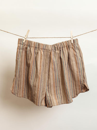 Handcrafted lounge shorts in brown with multicolored vertical stripes, designed with an elastic waistband and relaxed fit. Ethically made from sustainable materials, these shorts offer comfort and style for casual or lounge wear.