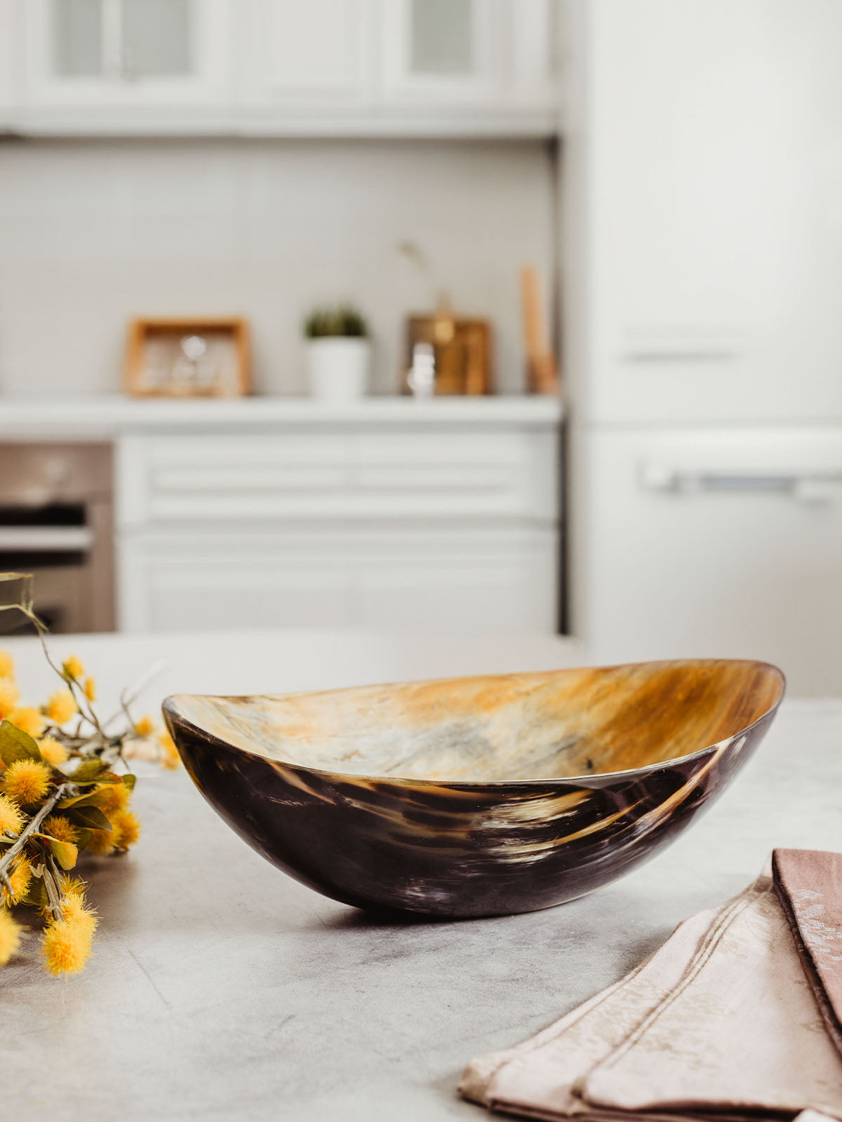 Centerpiece bowl made of horn on kitchen counter.