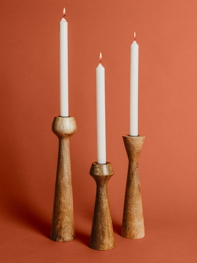 Wooden candle stand set on rustic orange studio background