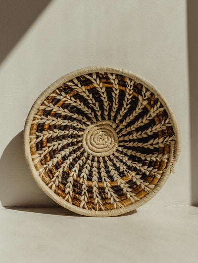 Small brown and tan basket on cream surface